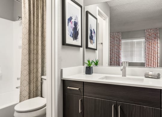 a bathroom with a toilet sink and bathtub in a 555 waverly unit